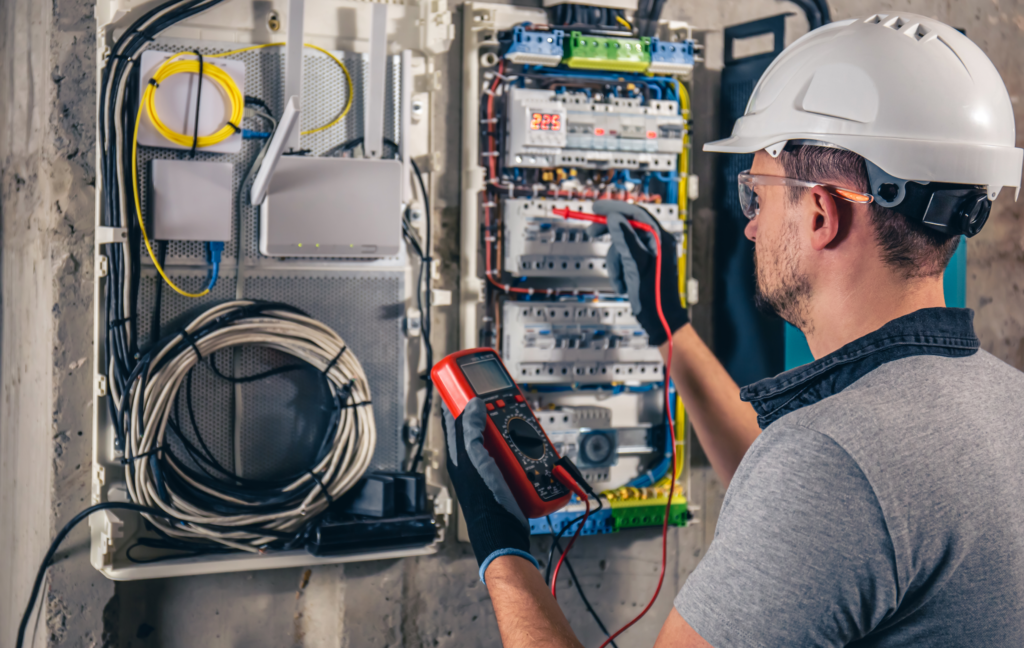 man-electrical-technician-working-switchboard-with-fuses 1